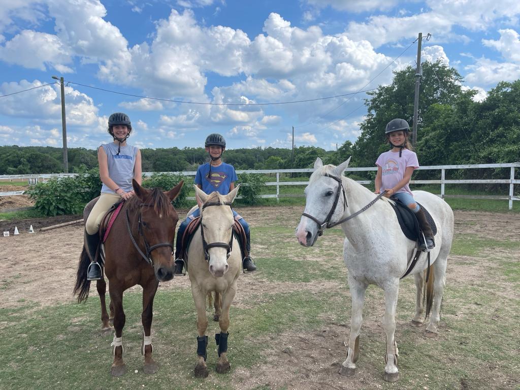 Kids on horses in round pen at Bel Canto Farms